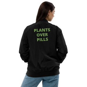 Black bomber jacket with 'Plants Over Pills' design, promoting holistic wellness, plant-based living, and sustainable fashion for health-conscious individuals.